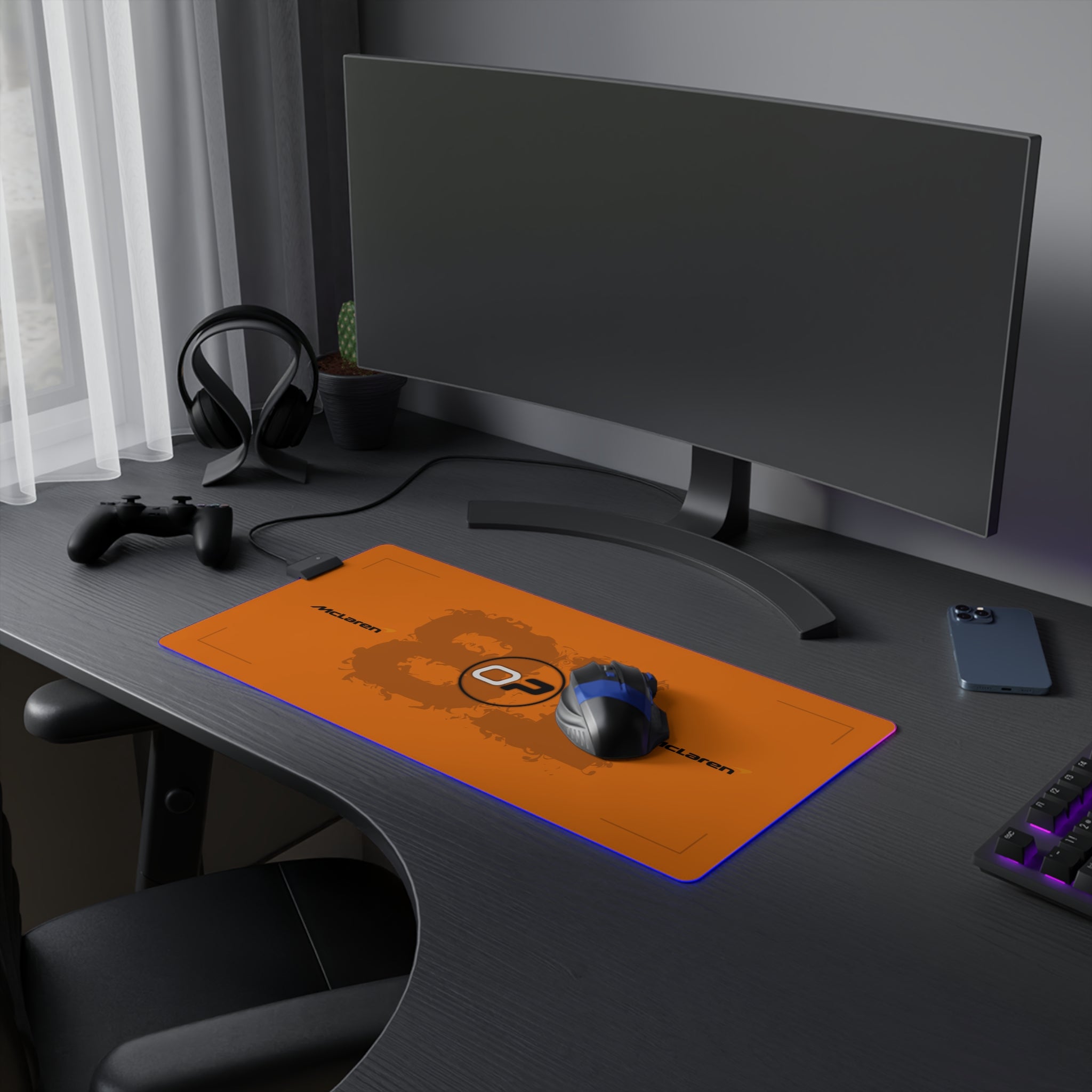 Orange and black racing-inspired gaming mouse pad with a smooth surface and modern Grand Prix design. Inspired by rising racing talent.