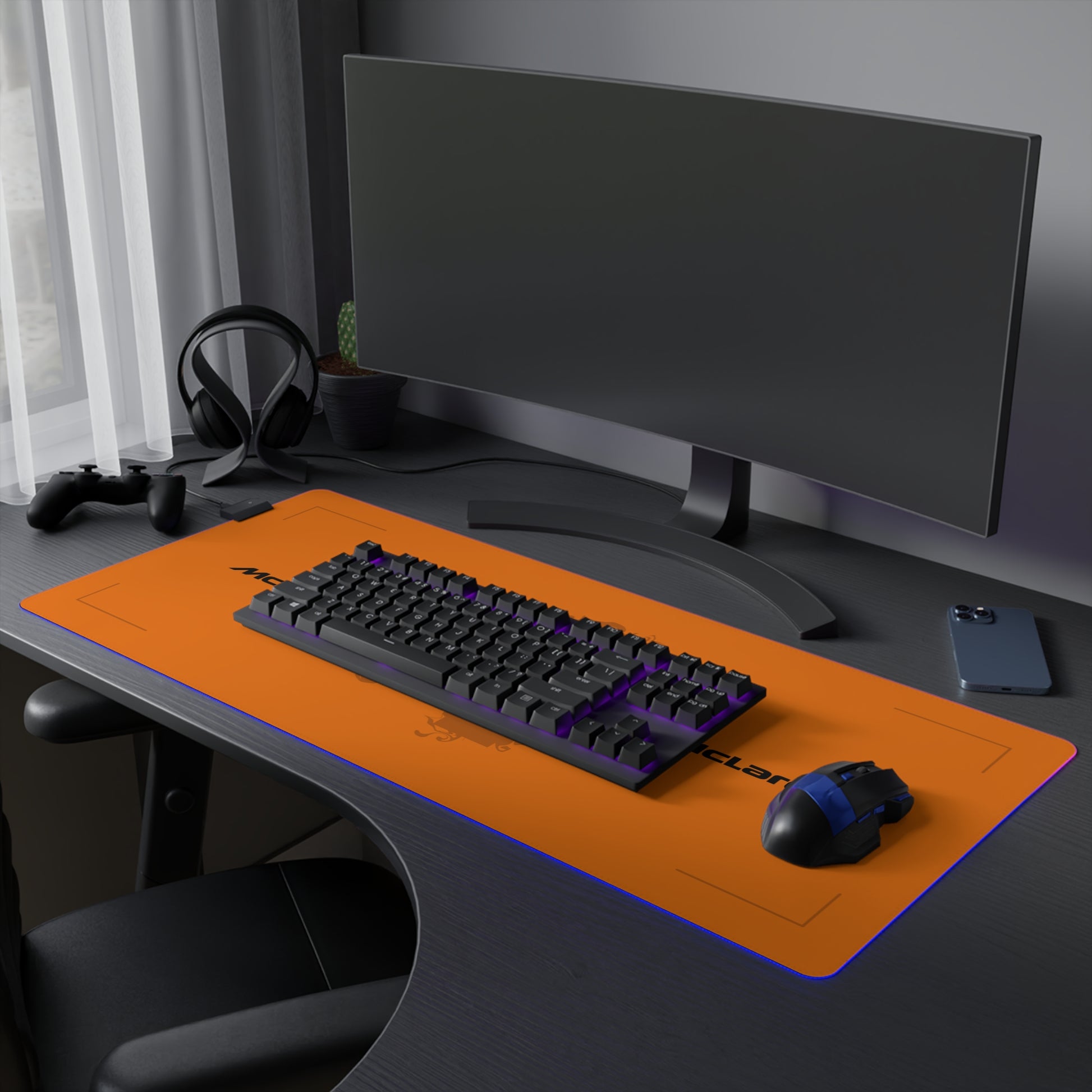 Papaya orange and black racing-inspired mouse pad with a high-performance glide surface. Inspired by young British racing talent.