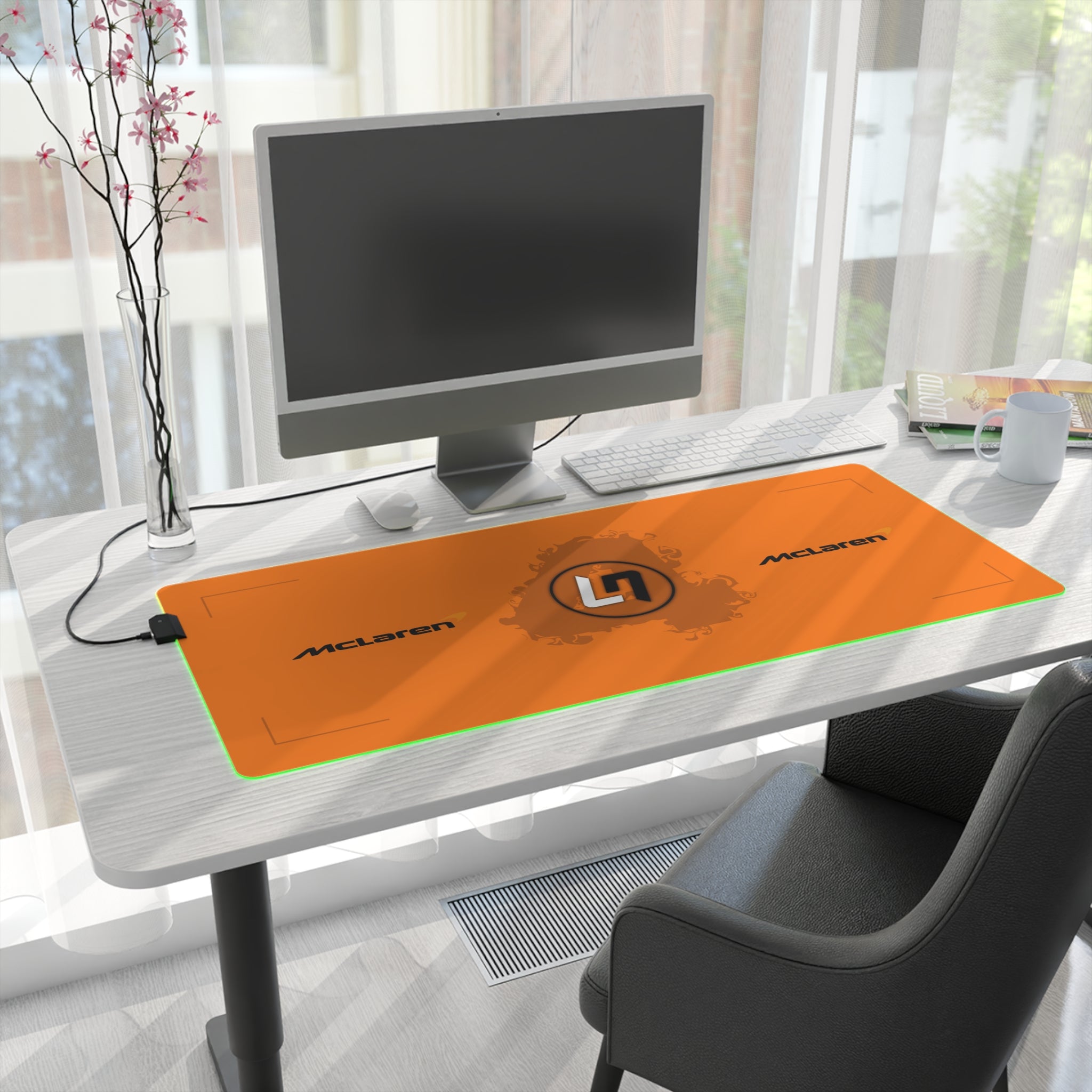 Papaya orange and black racing-inspired mouse pad with a high-performance glide surface. Inspired by young British racing talent.